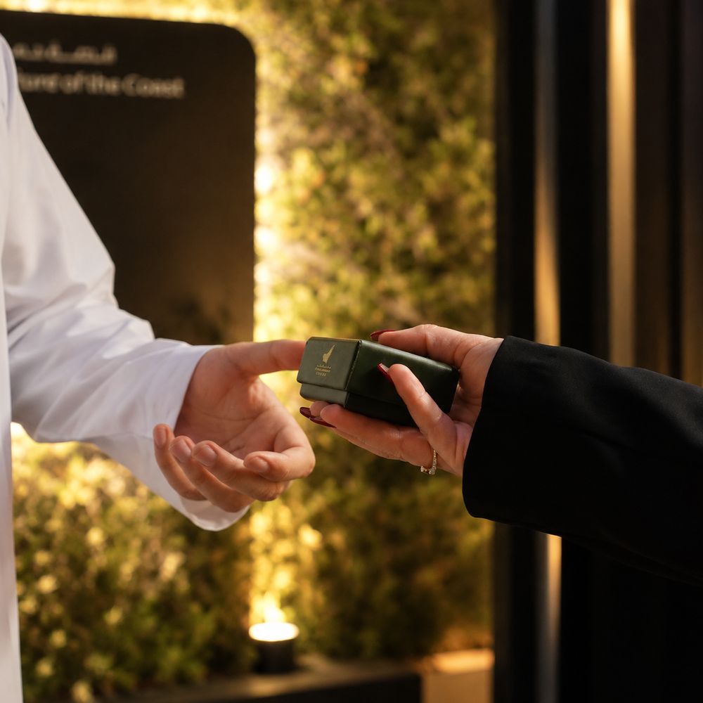 Guardians of the Coast gift being handed to a visitor – premium event experience