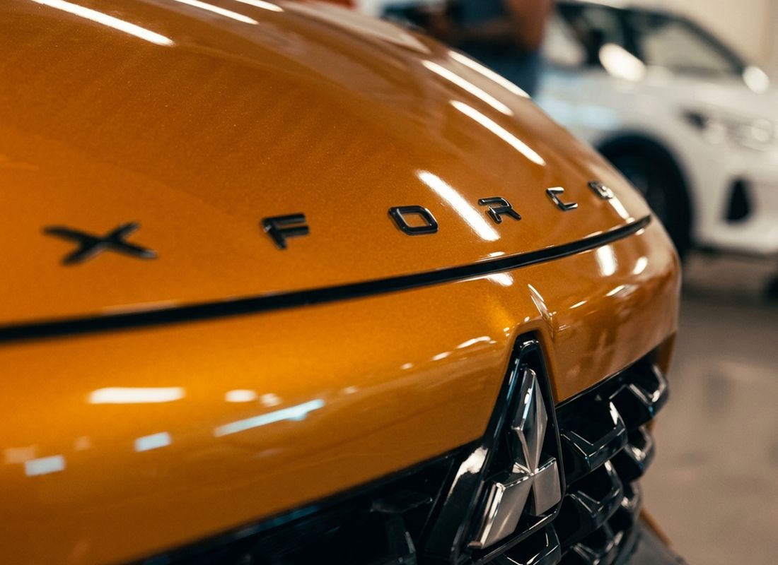 Close-up of the Mitsubishi XFORCE bonnet badge – campaign-ready automotive content Dubai